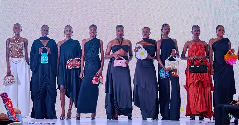 Models line the runway for a black evening collection finale