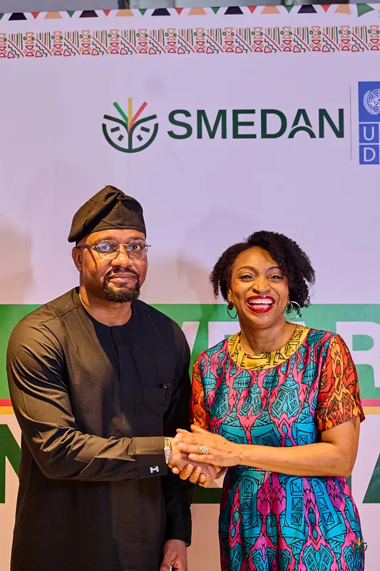 A warm handshake in front of the SMEDAN backdrop