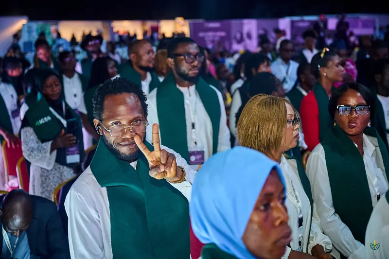 An ICSS programme graduate flashes a peace sign in the hall